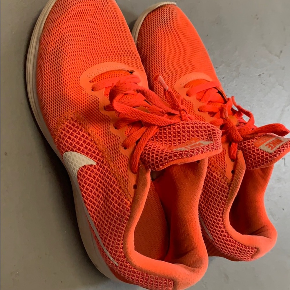 Worn neon pink/orange nike revolution 3 sneakers